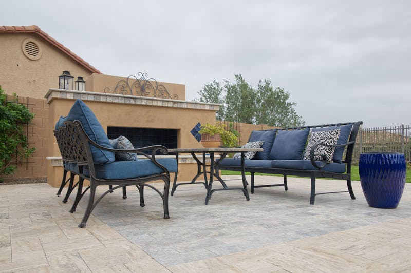 Patio with blue couch next to fire place